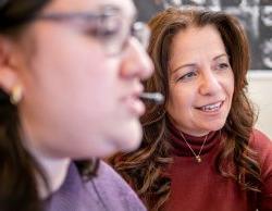 Elaine Hitchcock with student, engaging in student's work